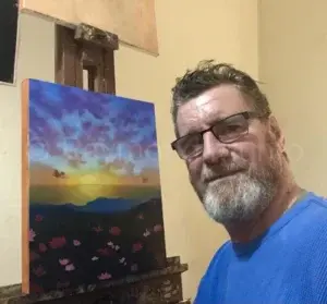 Raymond Munro working on oil painting of nature scene: Sunset over the sea with poppies.